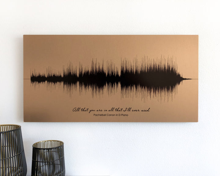 a sound wave art piece hanging on a wall, with a quote below it.